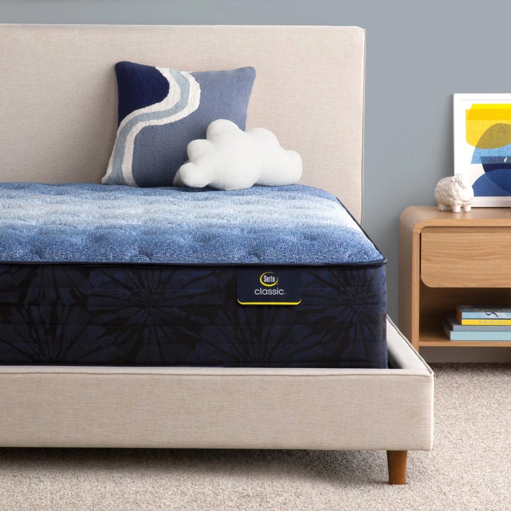 A Serta Classic mattress with a blue cover in a bedroom